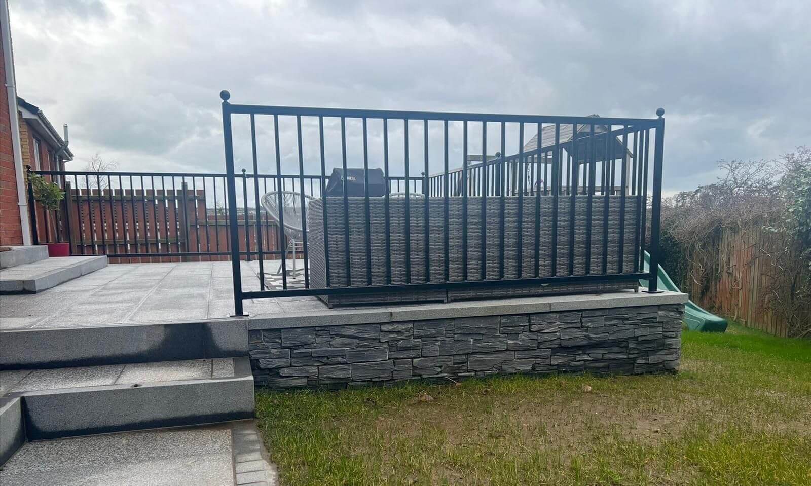 Modern black metal railings on raised patio deck