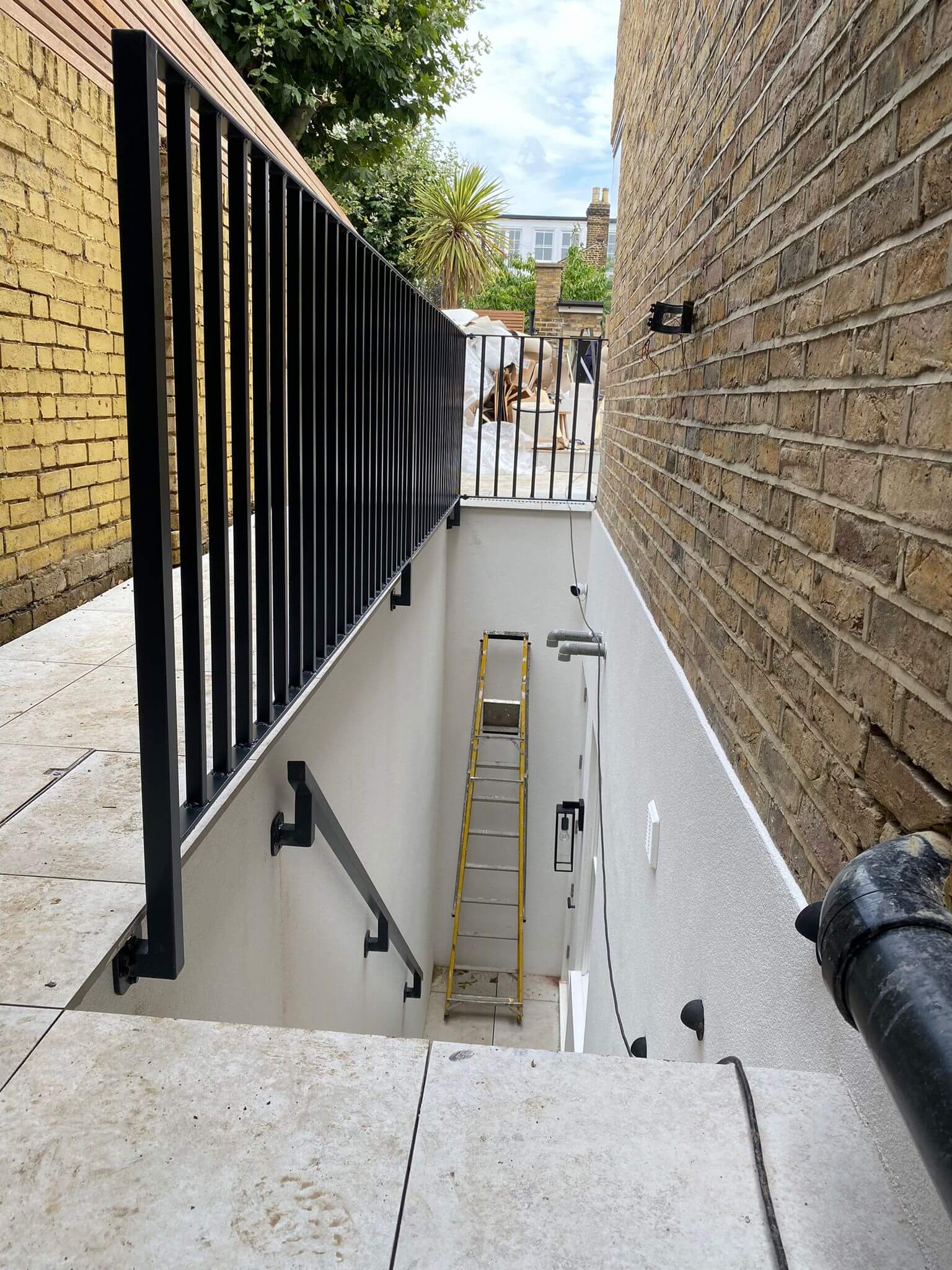 Modern vertical bar railings for basement access