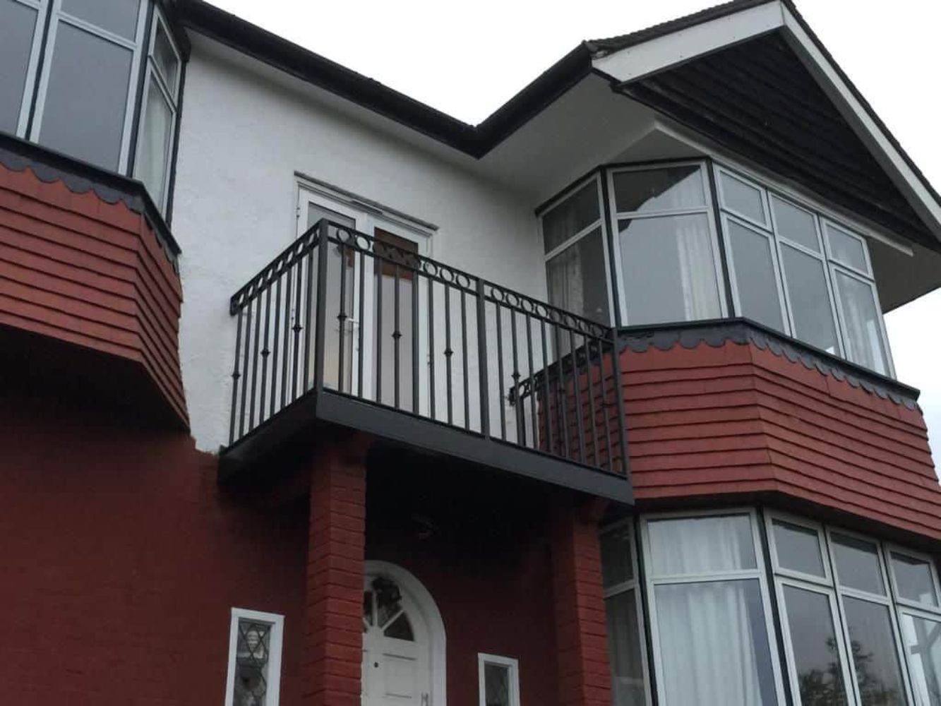 Traditional black wrought iron balcony with decorative elements