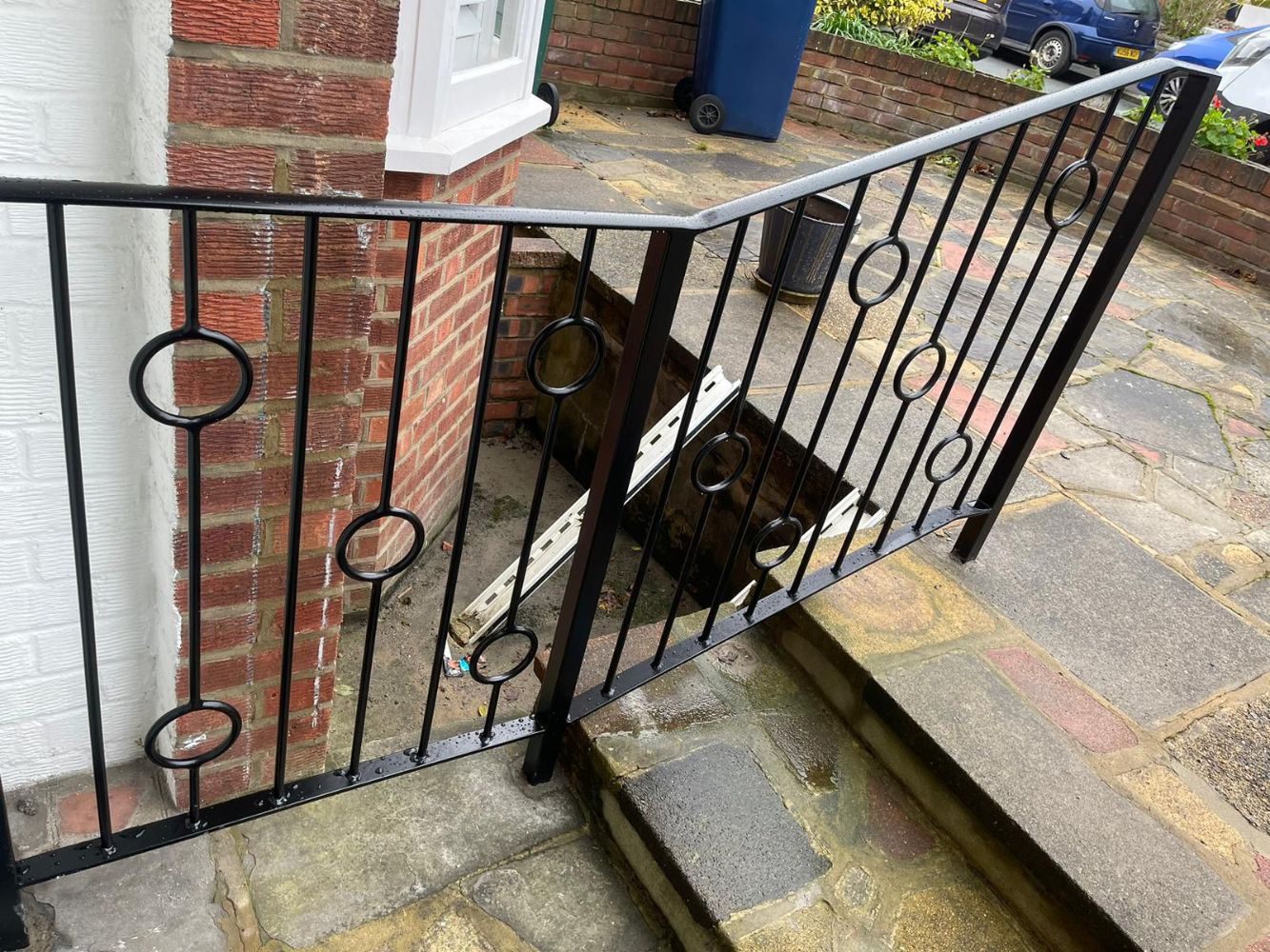 Black railings with circular ring details on residential steps