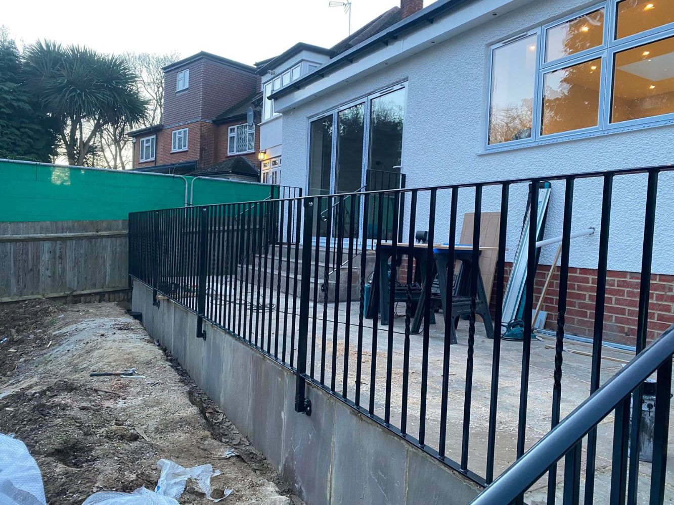 Black vertical bar railings on raised residential patio deck